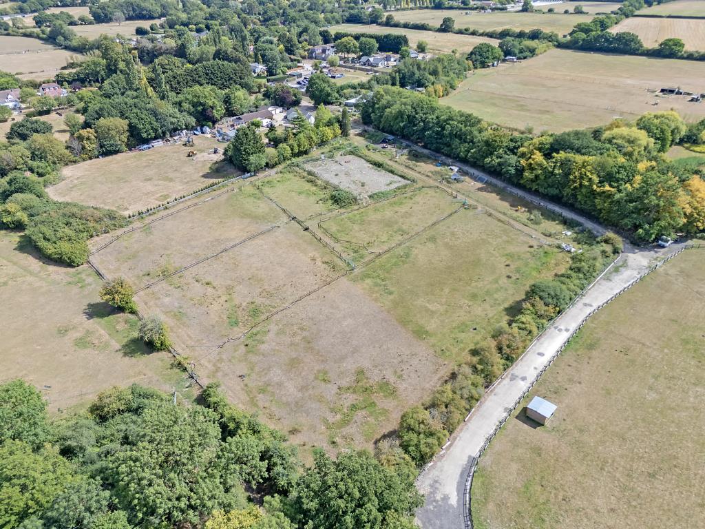 Lot: 72 - VACANT LAND IN VILLAGE LOCATION - Aerial drone shot of the land